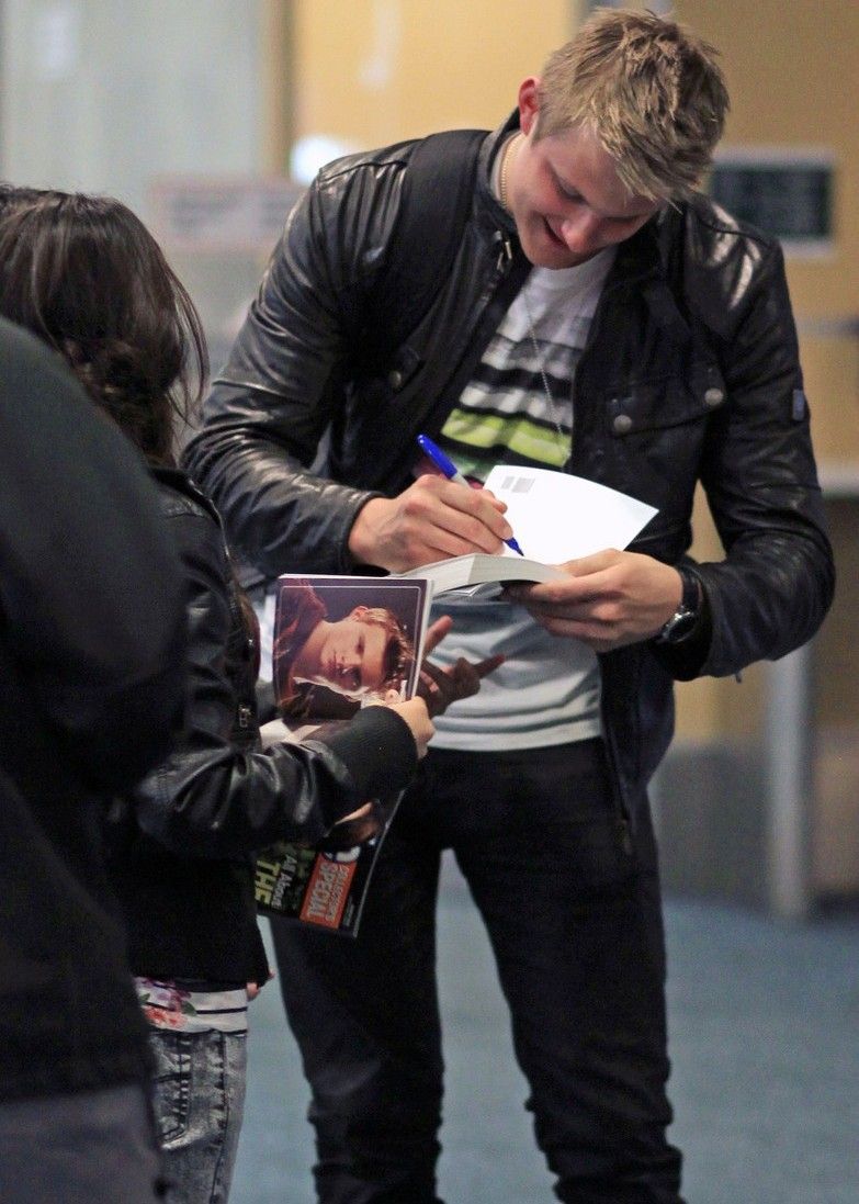 Alexander Ludwig greets some fans after landing at Vancouver International Airpor